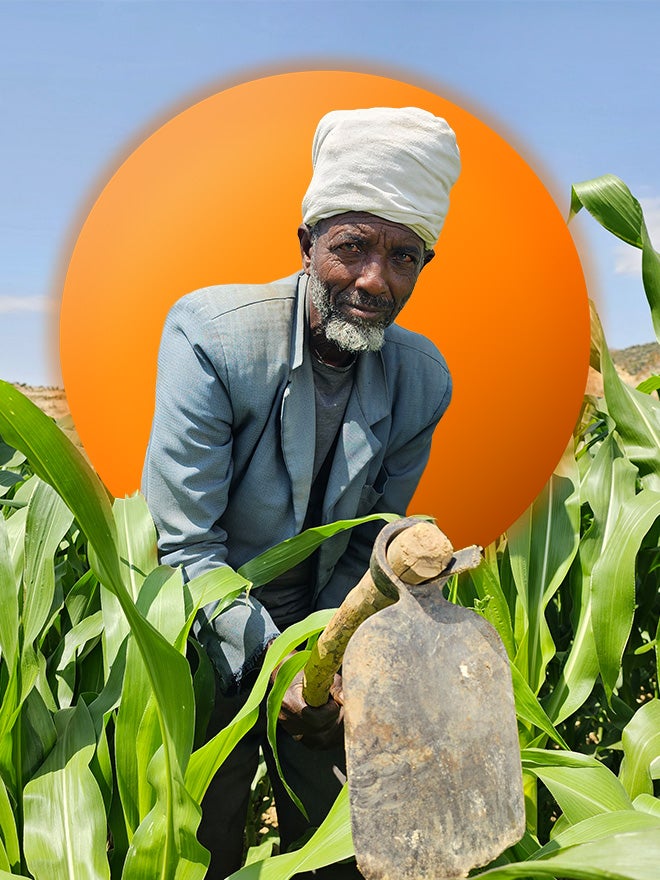 A man uses a hoe to work in a field