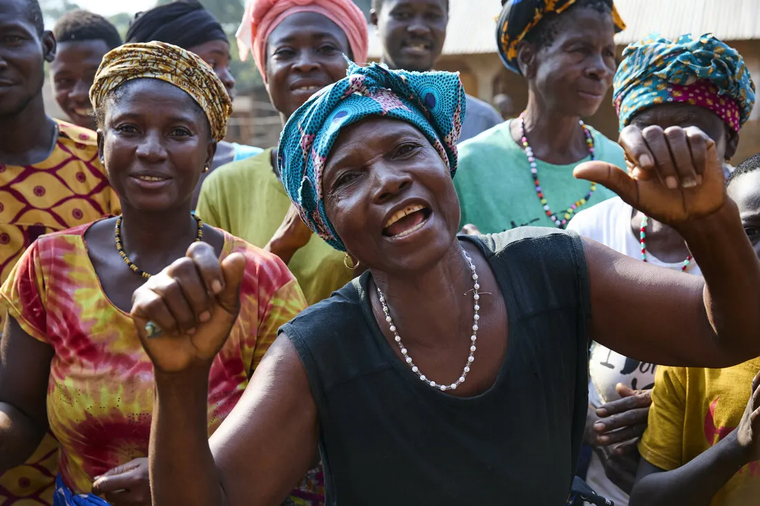 A group of women and men smiling.