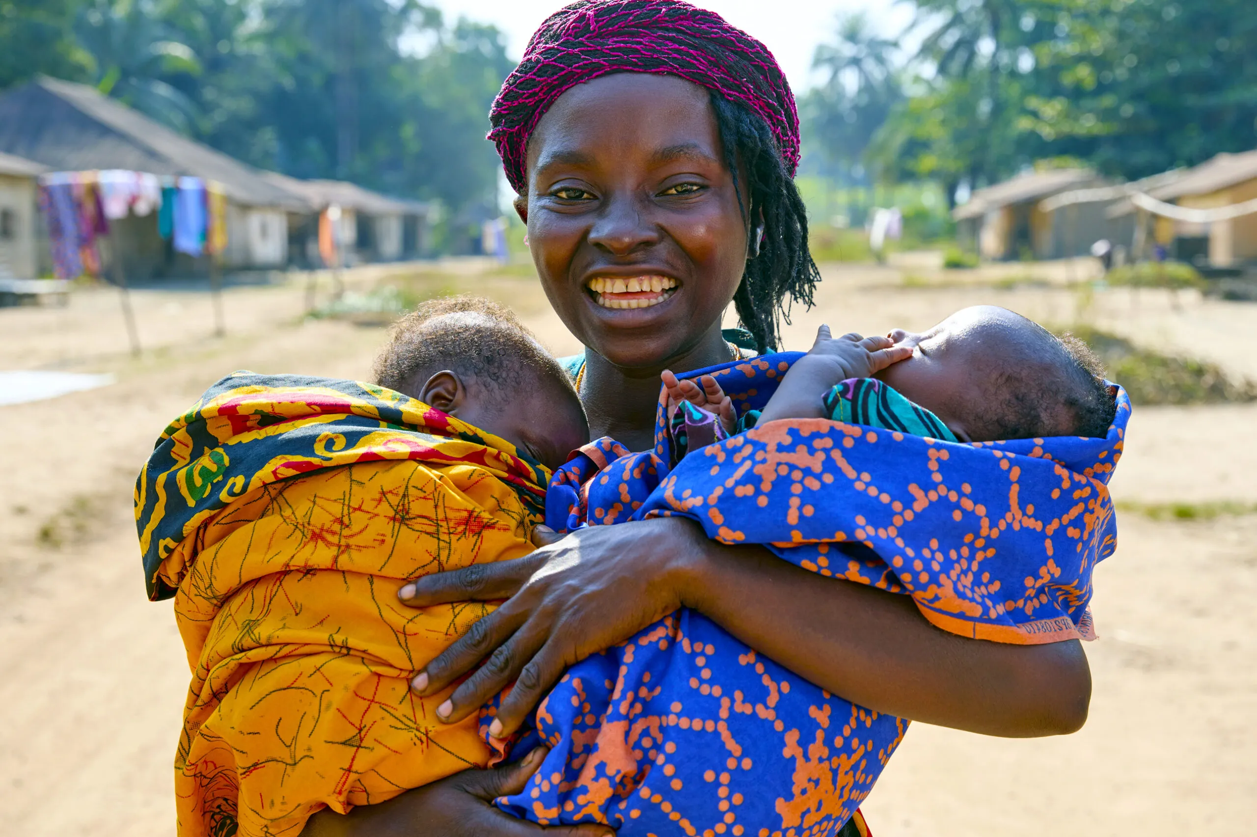 Mother holding her two infants