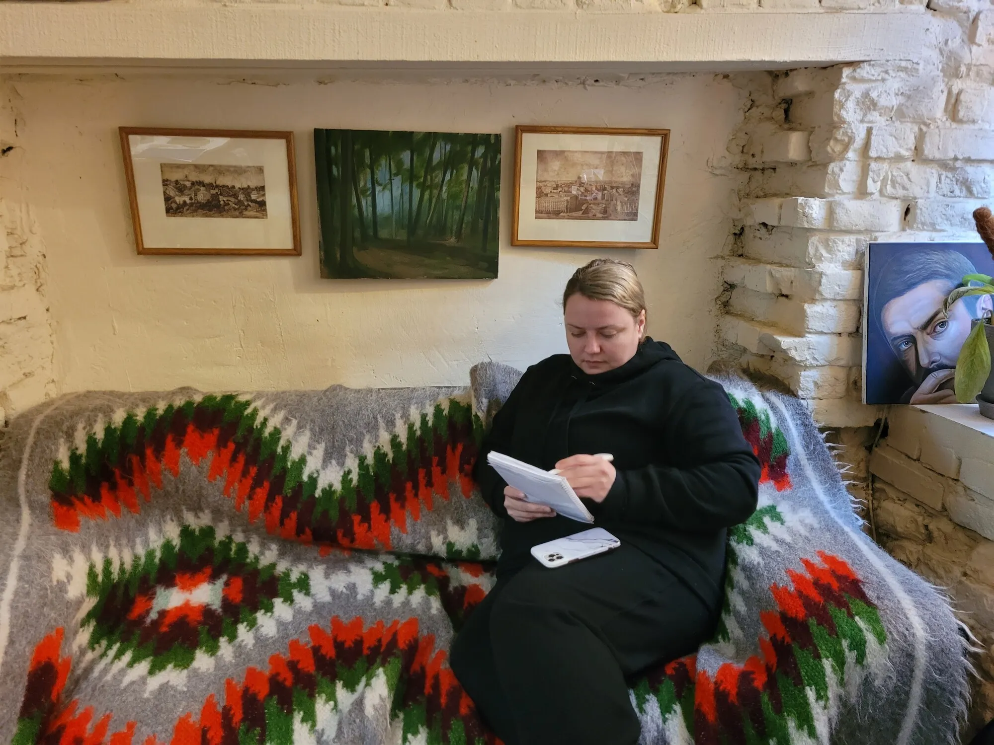 Portrait of Lyudmyla Yankina, writing in a notebook.