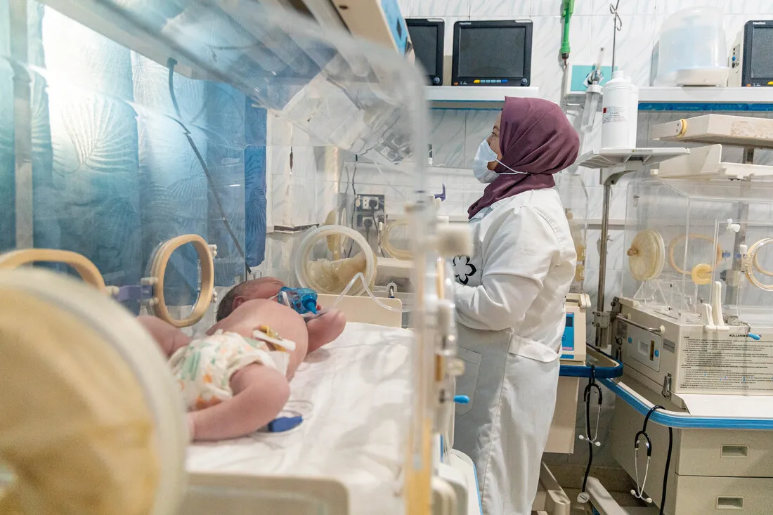 A woman in hijab heads to work as a neonatal nurse at the Al-Amal Maternity Hospital in Aleppo.