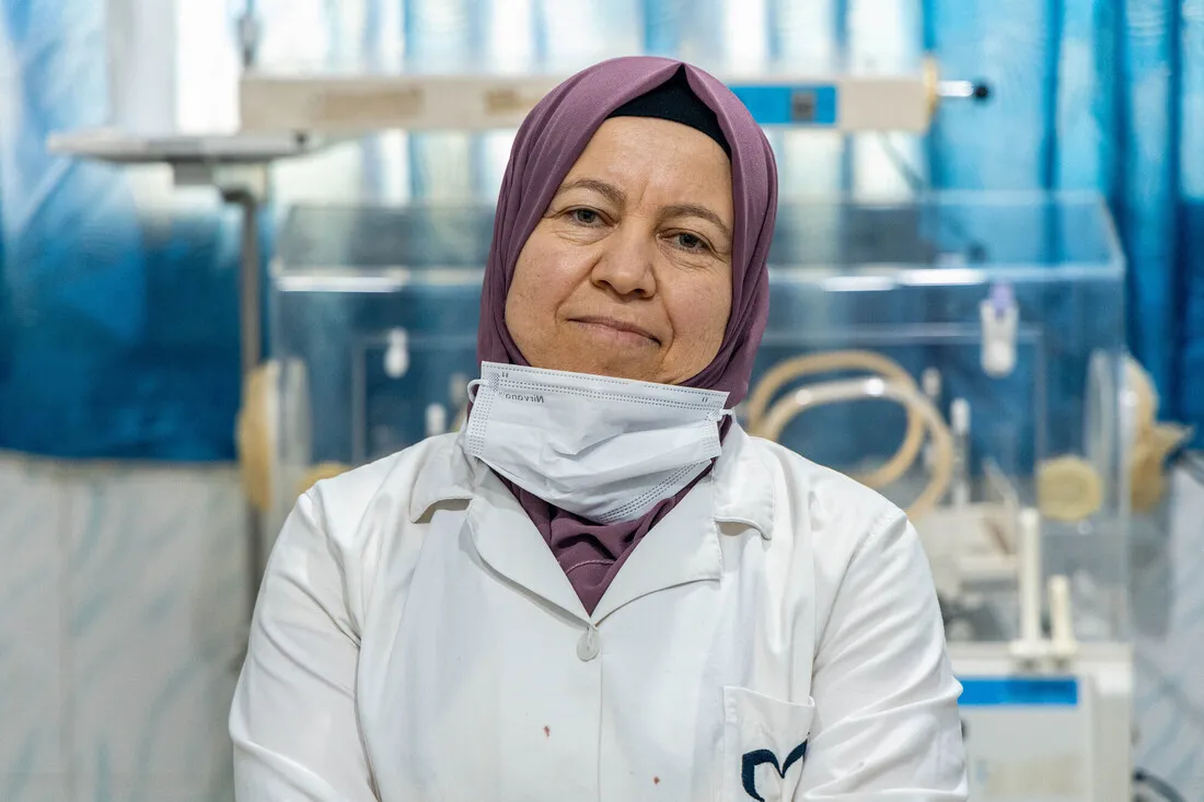 A healthcare worker in hijab and facemask stands in a neonatal care unit run by CARE partner Violet in Northwest Syria.